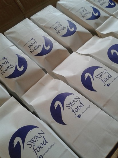 A bag of swan food with The Swan Food Project logo on it